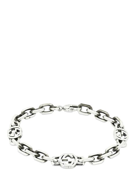 silver bracelet with interlocking g.